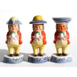A 19th century Staffordshire three-piece Toby cruet set, each character modelled standing wearing