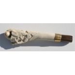A Japanese carved stag antler parasol handle, the carving of a monkey in a tree, with Brigg mount,