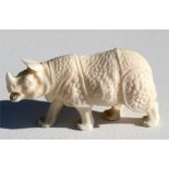 A Japanese Meiji Marine ivory carving in the form of a rhino, 7.5cm (3ins) long.