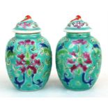 A pair of Chinese miniature vases and covers, decorated with flowers on a turquoise ground, 6.5cm (