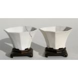 A pair of 18th century blanc de chine libation cups on stands, with calligraphy to the body, 12cm (