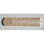 A Chinese Canton Export ivory cribbage board, carved with dragons and foliate scrolls, 21cm (8.