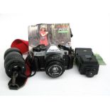 A Canon A E -1 35mm SLR camera, a Canon lens, a Hanimax 135 lens, flash gun and bag.