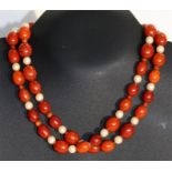 An amber and pearl necklace, total weight 76g, 94cm (37ins) long. largest bead 2cm long