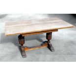 An oak rectangular topped dining table, on carved bulbous supports, 157cm (62ins) wide.