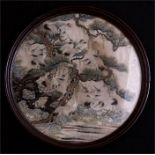 A 19th century Chinese circular silk embroidered panel depicting storks in a tree, framed and