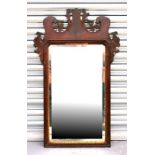 An early 19th century mahogany pier mirror with carved fretwork decoration, 54 by 86cm (21.25 by
