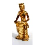 A Chinese gilt bronze figure in the form of a monk seated in contemplation, 30cm (12ins) high.