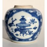 A Chinese blue and white ginger jar decorated with vases within panels, and prunus, having a