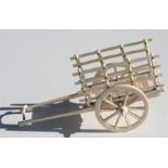 An early 20th century Indian ivory cart with spoked wheels, 14cm (5.5ins) long.