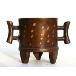 A small Chinese bronze gold splash two-handled tripod censer, 65cm (2.5ins) high.