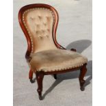 A Victorian mahogany button backed chair with cabriole front legs.