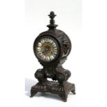 A bronze mantel clock, the case decorated with mythical beast masks and pineapple finial, the dial