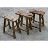 Three Chinese Shanxi elm stools, each approximately 46cm (18ins) wide.