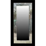 A large modern bevel edged wall mirror, 69 by 155cm (27 by 61ins).