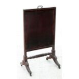 A Regency mahogany fire screen on splayed supports and joined by a stretcher, 56cm (22ins) wide.