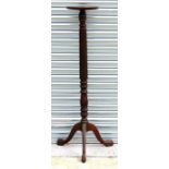A late Victorian mahogany torchere with turned and reeded column, standing on tripod base with