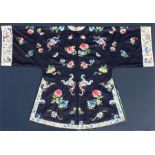 A 19th / 20th century Chinese silk embroidered robe, decorated with flowers and butterflies on a