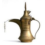 A Turkish or Islamic brass dallah coffee pot with foliate decoration, 28cm (11ins) high. Condition