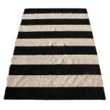 A modern Amagansett cream and black stripped rug, 268 by 185cm (105.5 by 73ins).