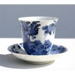 A Chinese blue & white cup and saucer, decorated with peacocks, flowers and insects; and having a