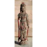 A Chinese carved wooden polychrome figure depicting Guanyin, 163cm (64ins) high.