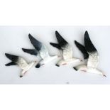 A set of three graduated Beswick seagull wall plaques; together with another similar (4).