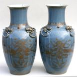 A large pair of Chinese powder blue ground vases, decorated with a gilded mountainous landscape