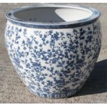 A very large Chinese blue and white fish bowl with decorated foliate scrolls and butterflies,