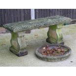 A well weathered stoneware garden bench, 115cm (45ins) wide; together with a circular bird bath top,