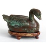 A Chinese bronze box and cover on stand, in the form of a goose, 10cm (4ins) high.