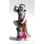 A Chinese figure depicting Liu Hai with a string of cash and his familiar, a three legged toad,