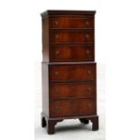 A reproduction mahogany bowfronted chest on chest, with six long graduated drawers, standing on