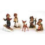 A group of Hummel figures, including a skiing boy and girl with geese (5).