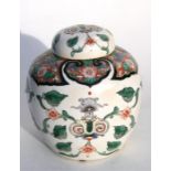 A 19th century Chinese vase and cover decorated with flowers and foliage in enamel colours and