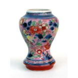 A 17th century Japanese clobbered vase, the decoration of dragons and flowers, 9cm (3.5ins) high.