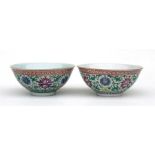 A matched pair of Chinese famille rose bowls, decorated with flowers in enamel colours, 17cm (6.