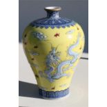 A 20th century Chinese meiping vase decorated in slight relief with dragons chasing a flaming