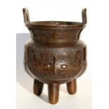 A Chinese bronze two-handled tripod censer, 32cm (12.5ins) high.