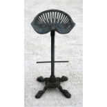 A cast iron tractor seat stool.