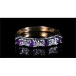 A 9ct gold dress ring set with four amethyst coloured stones and three diamonds. approx UK size R