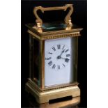An ornate brass cased carriage clock with white enamel face.​ Condition Report Looks to be in good