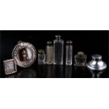 A silver capstan inkwell; two miniature silver photo frames; and a group of silver mounted and other