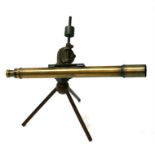 A 19th century brass astronomical telescope on a wooden tripod stand, the telescope 67cms (26.25ins)