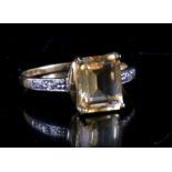 A 9ct gold ring set with a central square citrine and diamond shoulders.