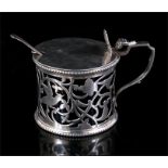 A large silver mustard pot with ornate pierced decoration and blue glass liner. Birmingham 1901,