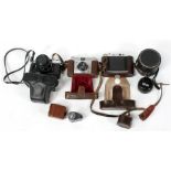 A Solida II folding camera; a Fujica model S.T705 35mm camera; and other cameras and lenses.