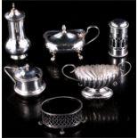 A collection of silver open salts, mustard pots and pepper casters, some with blue glass liners.