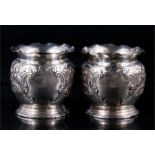 A pair of silver vases with embossed decoration, indistinct Chester hallmarks. 8cm ( 3.1ins) high.