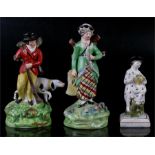 A pearlware figure 12.5cm (5ins) high, and two early Staffordshire hunting figures (a/f) . (3)